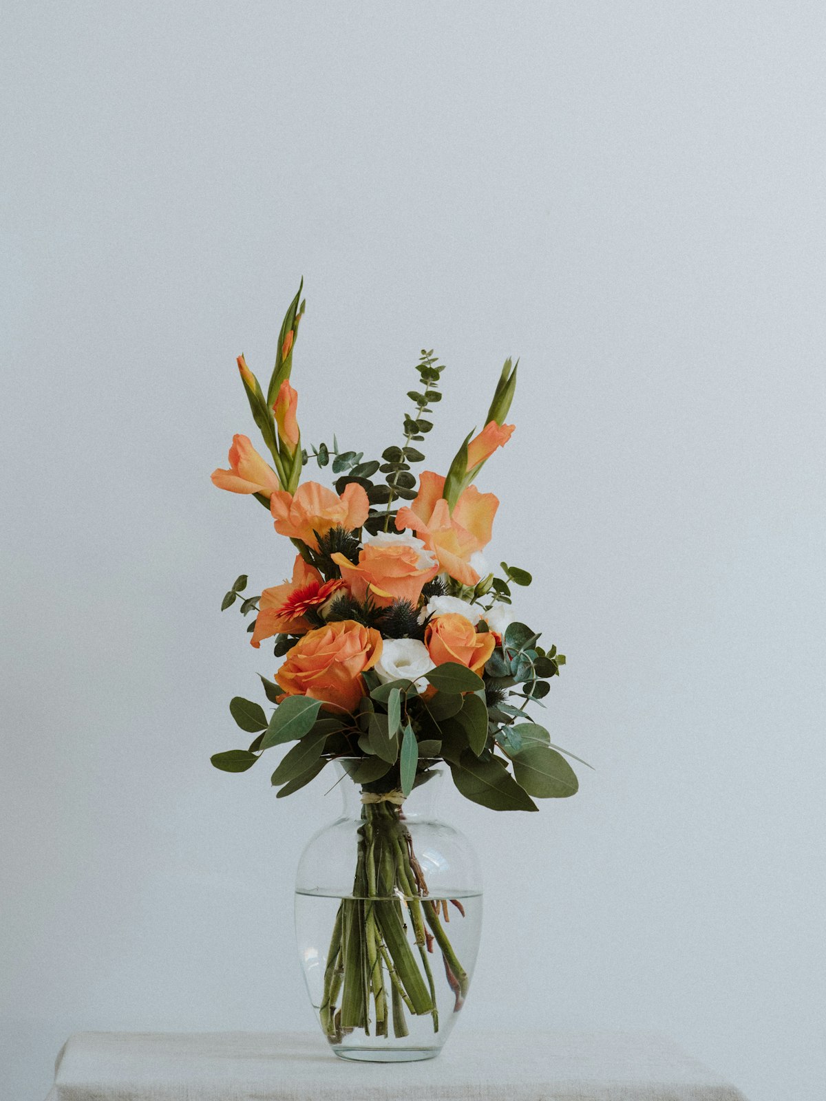 Bouquet orange et corail dans un vase